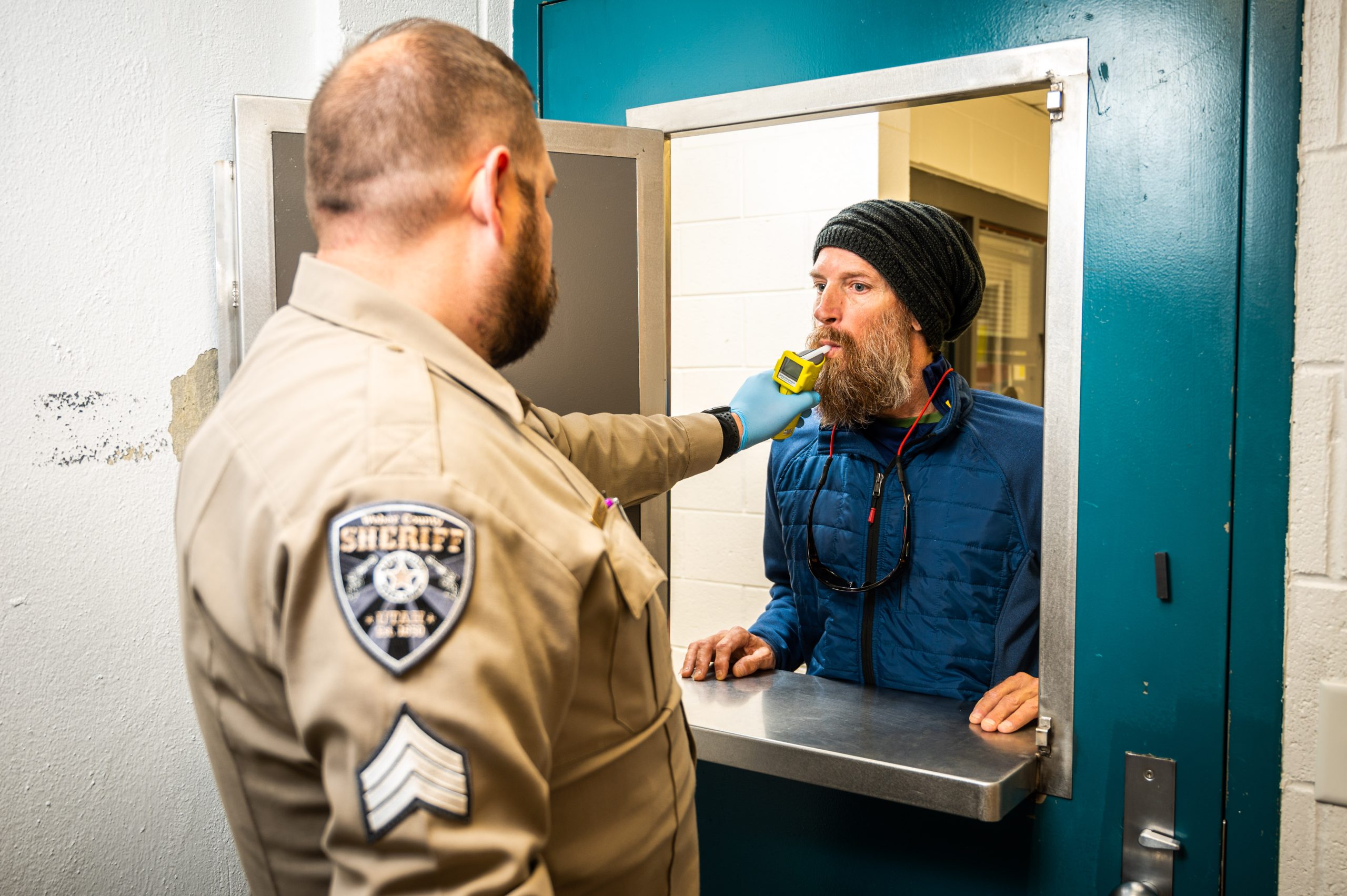 Deputy administers a breath test as part of the 24 7 sobriety program